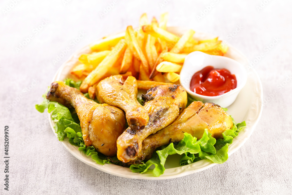 grilled chicken leg, french fries and ketchup grilled chicken leg, french fries and ketchup