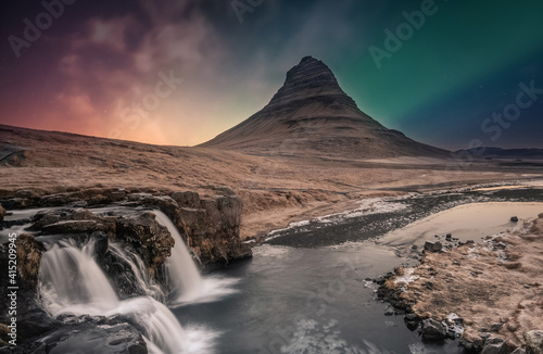 Northern lights aurora borealis over kirkjufell waterfall in Iceland