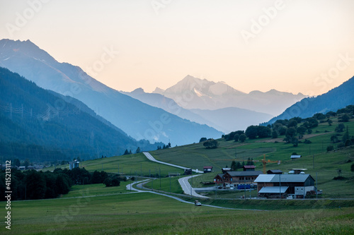 beautiful mountain peak seen from  alpine valley whit street and houses at sunset swiss alps goms valais