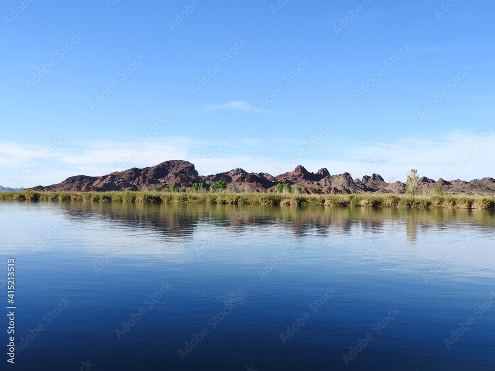 The beautiful lower Colorado River flowing through the desert, with jagged peaks in the background, Picacho State Recreation Area, Imperial County, California.	
