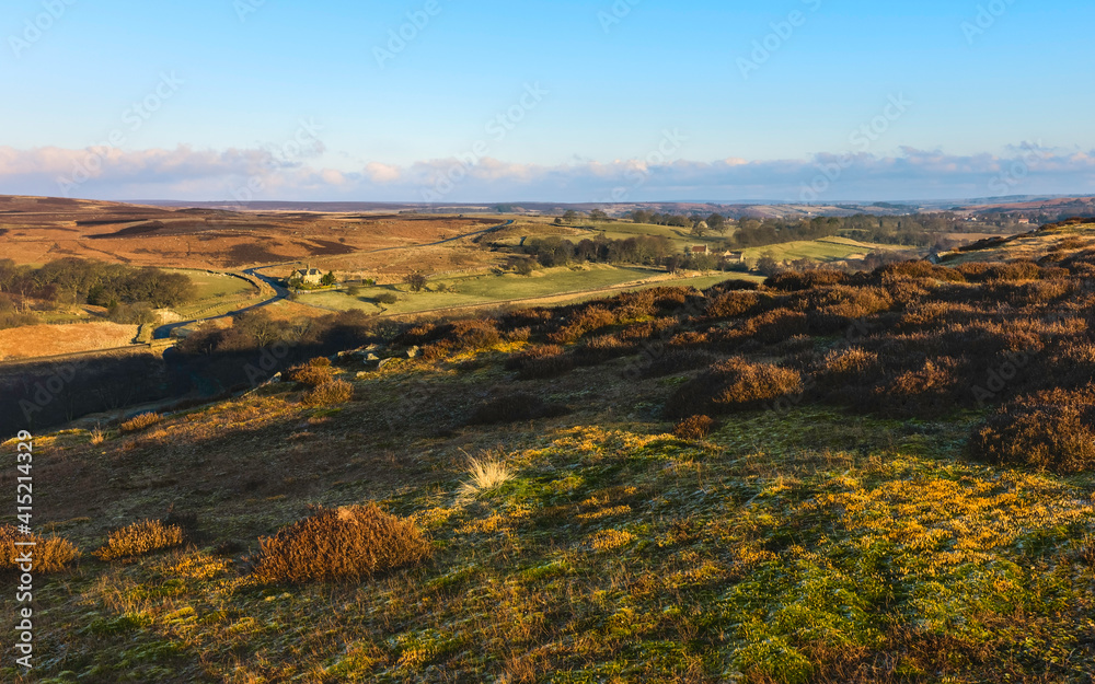 Sunrise over the North York Moors under blue sky. Goathland, UK.