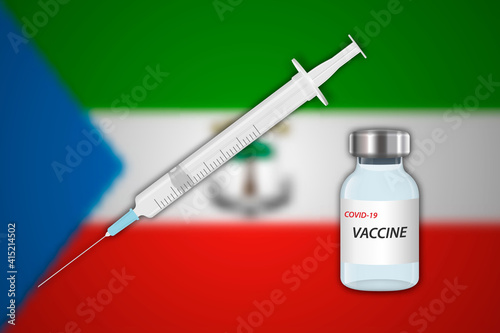 Syringe and vaccine vial on blur background with Equatorial Guinea flag,