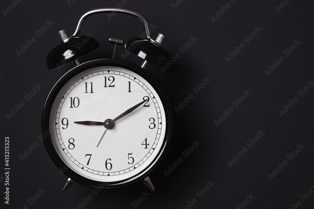 Alarm clock on a dark background in Low-key lighting Alarm clock on a dark background in Low-key lighting