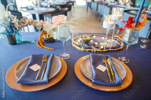 blue wedding cake stands on a blue table © Alexander