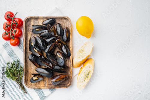 Fresh Mussels with ingredients, on wooden tray, on white background, top view flat lay , with copyspace and space for text