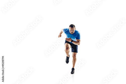 In air. Caucasian professional male athlete, runner training isolated on white studio background. Muscular, sportive man. Concept of action, motion, youth, healthy lifestyle. Copyspace for ad.