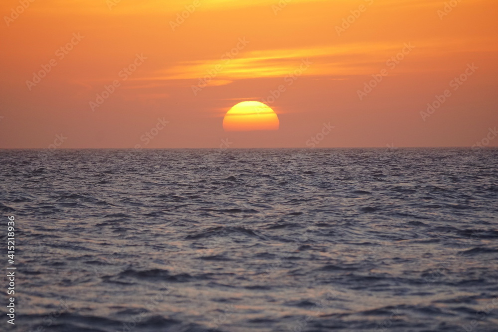 Beautiful sunset and red sky by the ocean near Madeira Beach, Florida, U.S.A
