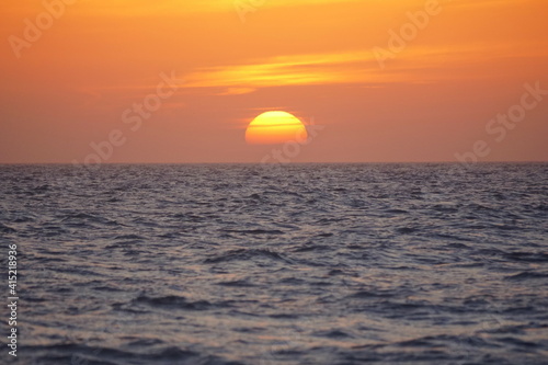Fototapeta Naklejka Na Ścianę i Meble -  Beautiful sunset and red sky by the ocean near Madeira Beach, Florida, U.S.A