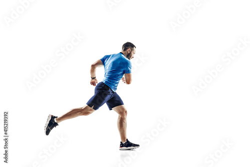 Purpose. Caucasian professional male athlete, runner training isolated on white studio background. Muscular, sportive man. Concept of action, motion, youth, healthy lifestyle. Copyspace for ad.