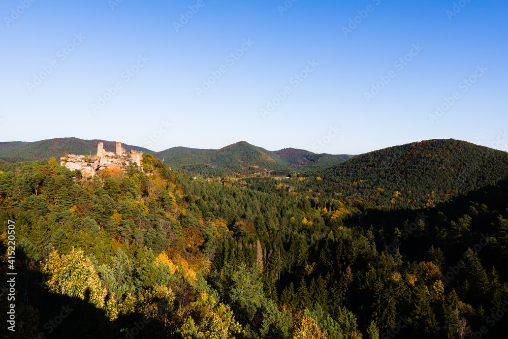 View from the rock over the valley with a romantic castle ruin.