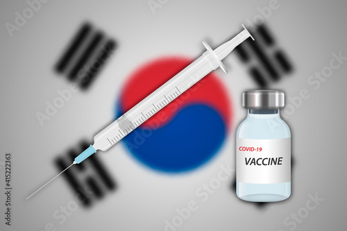 Syringe and vaccine vial on blur background with South Korea flag