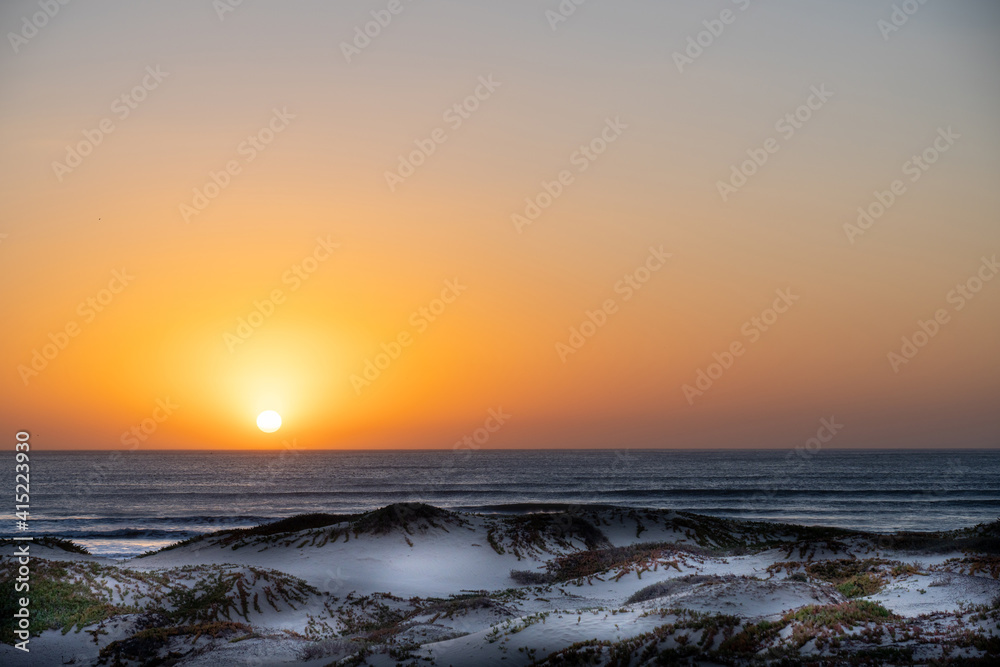 Sunset over the Ocean, sand dunes, sun 