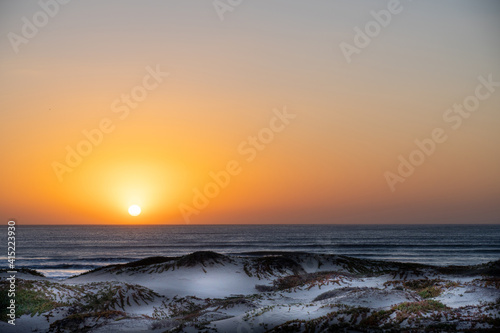 Sunset over the Ocean  sand dunes  sun 