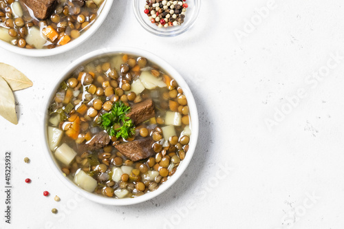 Detox green lentil soup in bowls. Space for text, flat lay, top view.