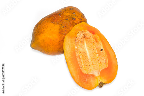 Half of the whole and ripe papaya fruit is isolated on a white background. Rotten papaya on a white background