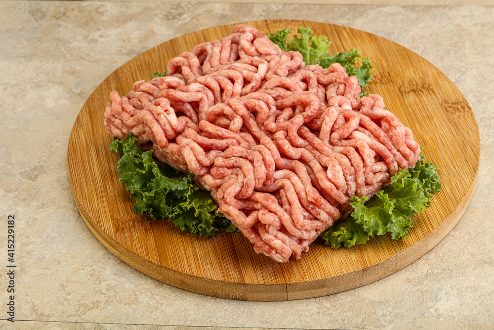 Raw pork minced meat over board Raw pork minced meat over board