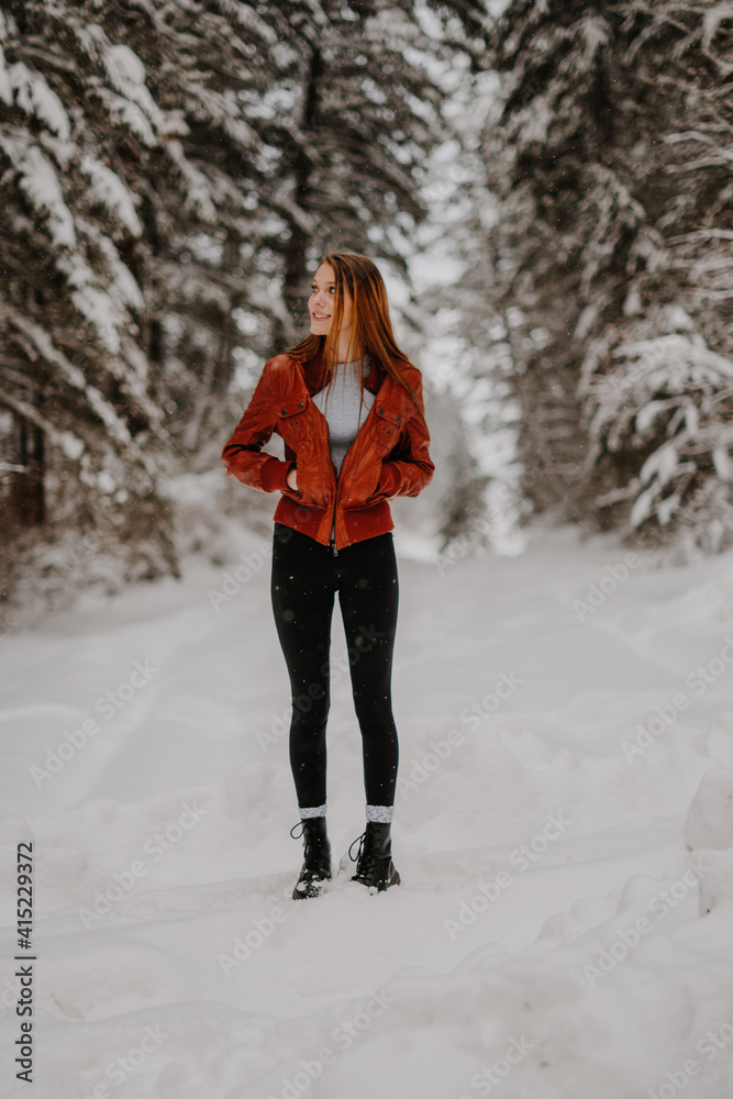 woman walking in winter forest