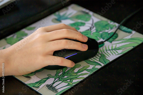 Hand of a mouse on a mousepad photo
