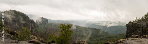 Elbe sandstone mountains in foggy clouds photo