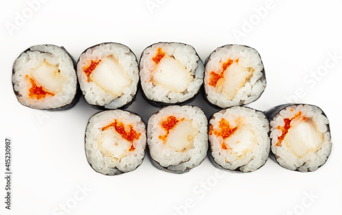 Sushi mini roll with fried sea bass on a white plate, ingredients fried bass, flying fish roe, rice, nori. Traditional Japanese food. For the restaurant menu.