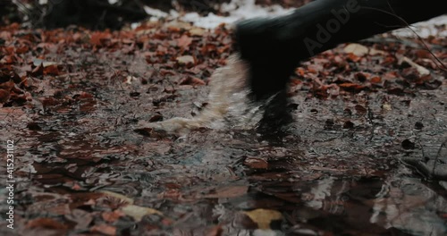 Male soldier in black boots quickly fast runs footsteps on mud, water, leaves 4k slow motion photo