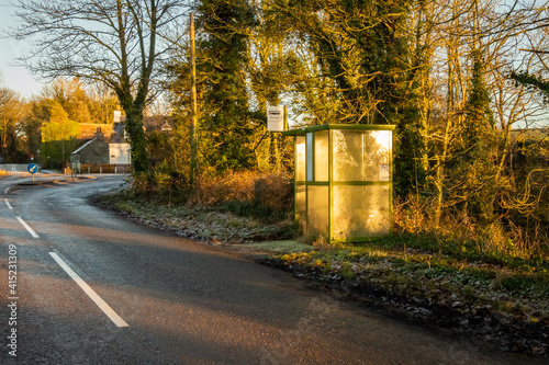 A rural bus stop in the winter sun at Tongland Bridge, Kirkcudbright, Scotland photo