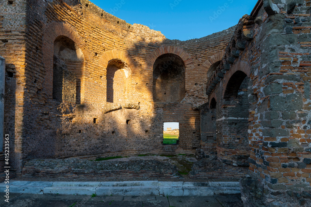 Fototapeta premium Detail of the apse of Nymphaeum of the Villa dei Quintili on the Appia Antica in Rome, on a sunny summer day and blue sky with the window. The regina viarum that connected Rome to Brindisi, Italy.