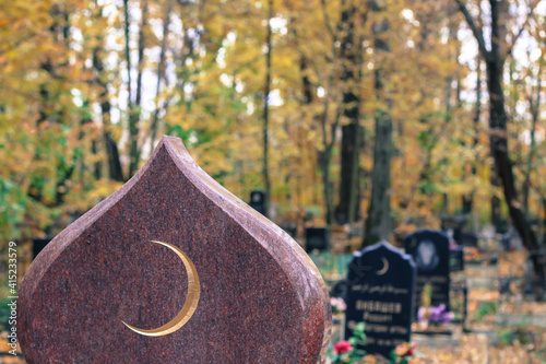 Photography Golden muslim crescent moon on a granite tombstone