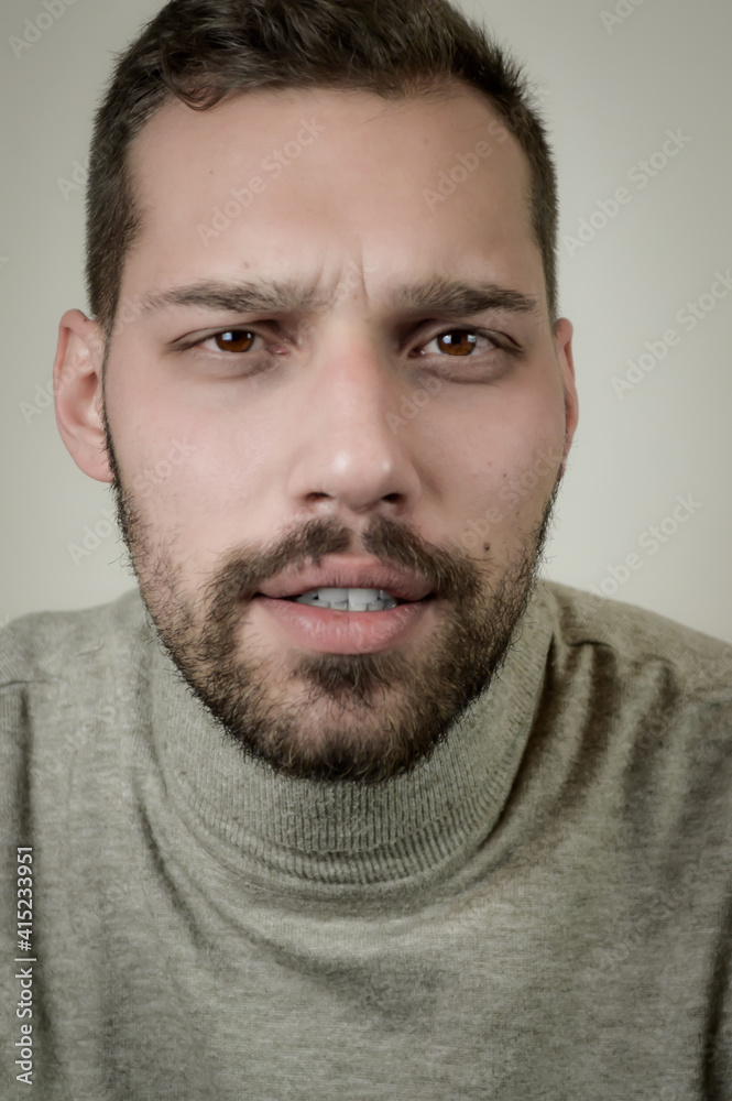 Portrait of a young man with a short beard looking worried about something Portrait of a young man with a short beard looking worried about something