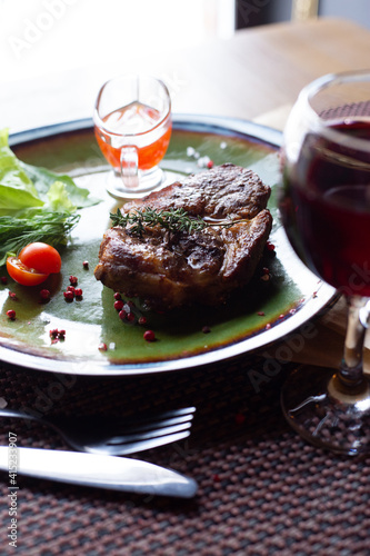 Pork steak with sauce, herbs and wine