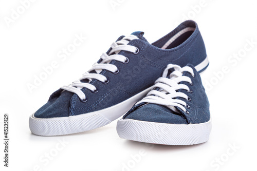 blue sneakers on white background with copy space. Youth shoes.