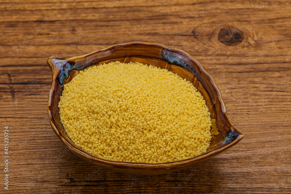 Raw cous cous heap in the bowl Raw cous cous heap in the bowl