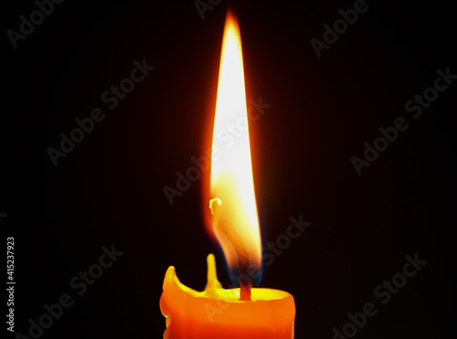 One light candle burning brightly,Candle light close up on black background. Burning candle. Candle Flame. 