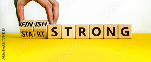 Start and finish strong symbol. Businessman turns wooden cubes, changes words 'start strong' to 'finish strong'. Beautiful white background, copy space. Business and start and finish strong concept. photo