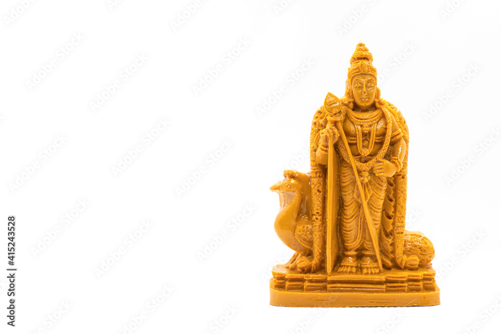 The hand-carved wooden statue of Lord Murugan is isolated on a white background