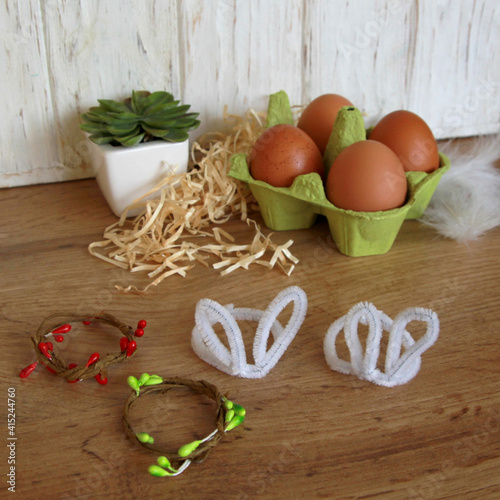 Fototapeta Naklejka Na Ścianę i Meble -  How to decorate an Easter egg in the form of cute animals. Step 5. We make the required number of bunny ears and wreaths. DIY concept. Step by step photo instruction