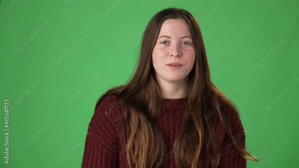 Young beautiful funny casual female video call using electronic device web cam. Teen girl talking to friends family online blogging, waving hand, laughing green screen chroma key. Camera point of view