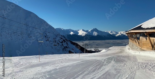 Famous Ski Slope at the Top of the Mountain on a Clear, Sunny, Cold Day; There Are Large Glaciers in the Distance; Vacation Ideas, Winter Sports, Adventures photo