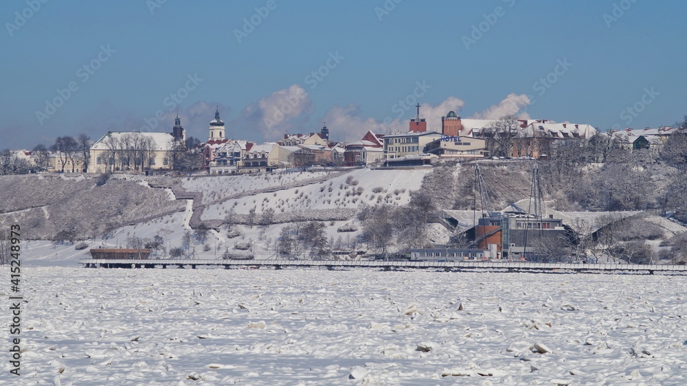 A view of the frozen Vistula river and the panorama of Płock in winter.