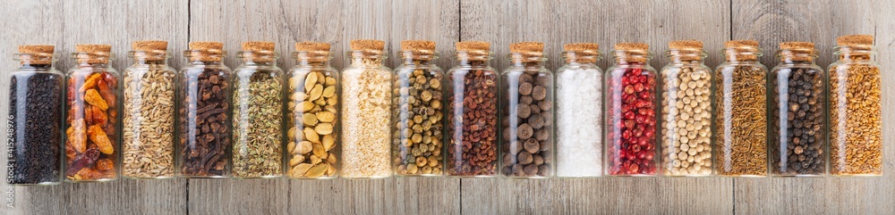 Panoramic view of glass jars with different spices and pepper Panoramic view of glass jars with different spices and pepper