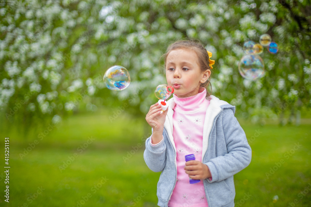 Beautiful little blonde girl, has happy fun cheerful smiling face, soap bubble blower. Beautiful little blonde girl, has happy fun cheerful smiling face, soap bubble blower.