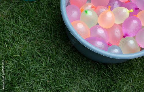 Container filled with water ballons. Copy space