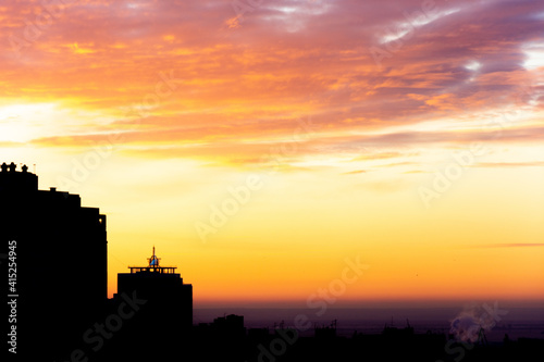 The sun rises over a large city in winter. Beautiful winter sunrise