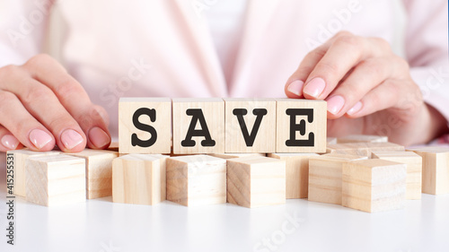 woman made word SAVE with wooden blocks