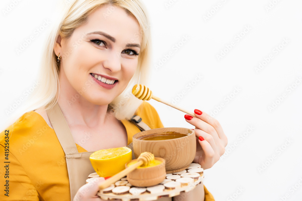 smiling young woman with bowl of honey on white background smiling young woman with bowl of honey on white background