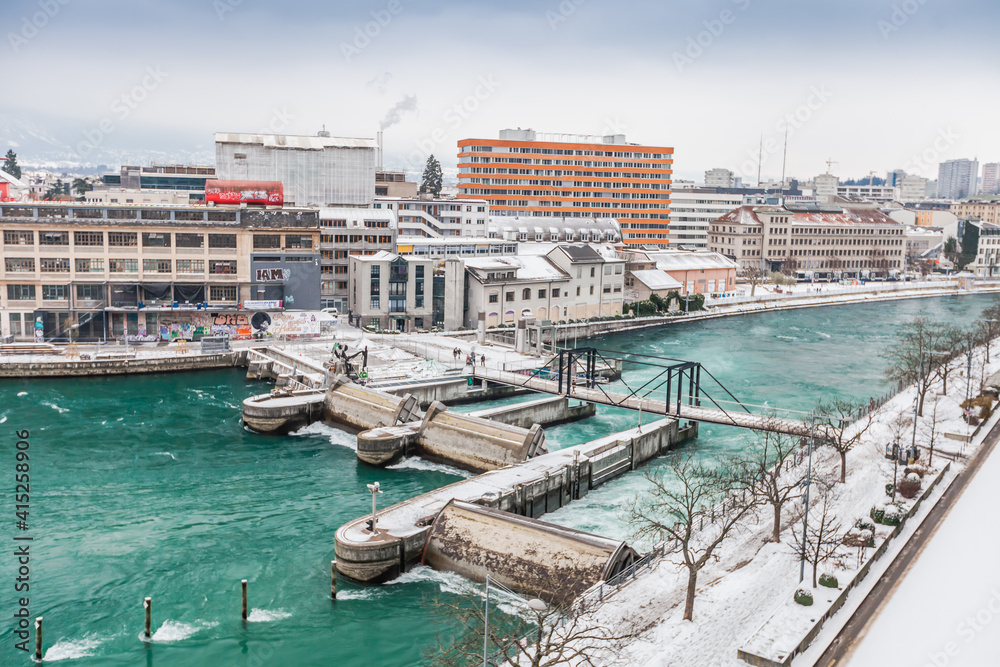 GENEVA, SWITZERLAND - February 13, 2021: Opened waterlocks on the Rhone after snow blizzard, Geneva, Switzerland.