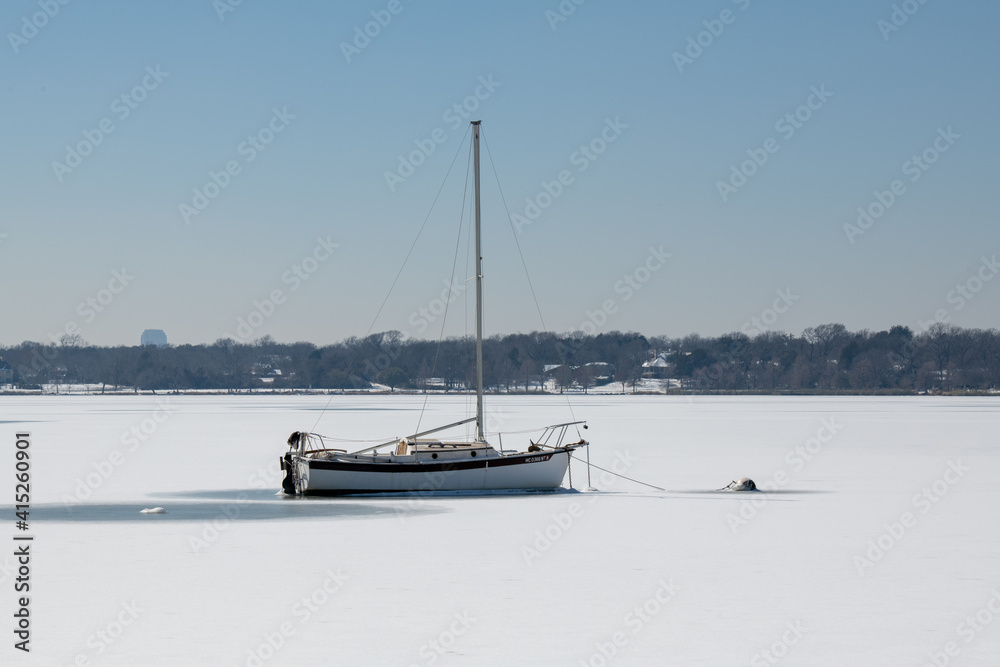 A scene of White Rock Lake in Dallas Texas with sailboats in view after a hard freeze and snow storm in February 2021 A scene of White Rock Lake in Dallas Texas with sailboats in view after a hard freeze and snow storm in February 2021