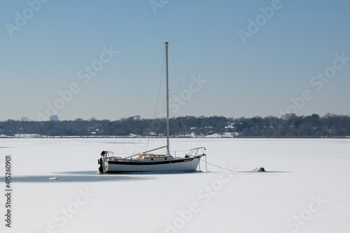 A scene of White Rock Lake in Dallas Texas with sailboats in view after a hard freeze and snow storm in February 2021
