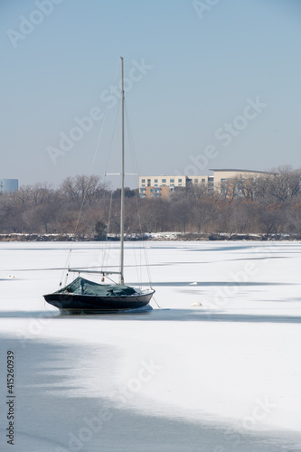 A scene of White Rock Lake in Dallas Texas with sailboats in view after a hard freeze and snow storm in February 2021