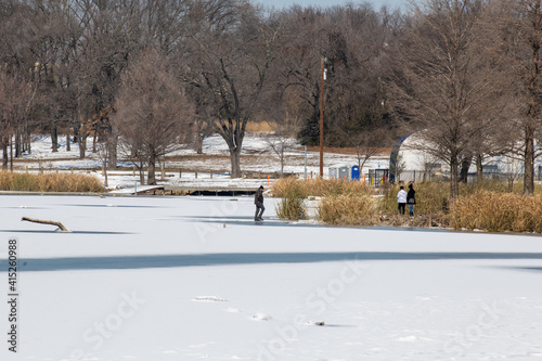 People walking on White Rock Lake in Dallas Texas after a hard freeze and snow storm in February 2021